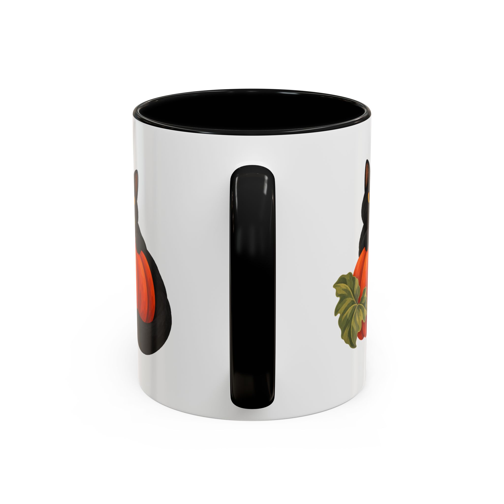 White 11 oz accent mug viewed towards its black handle, with the edges of the cat and pumpkin artwork visible on both sides.