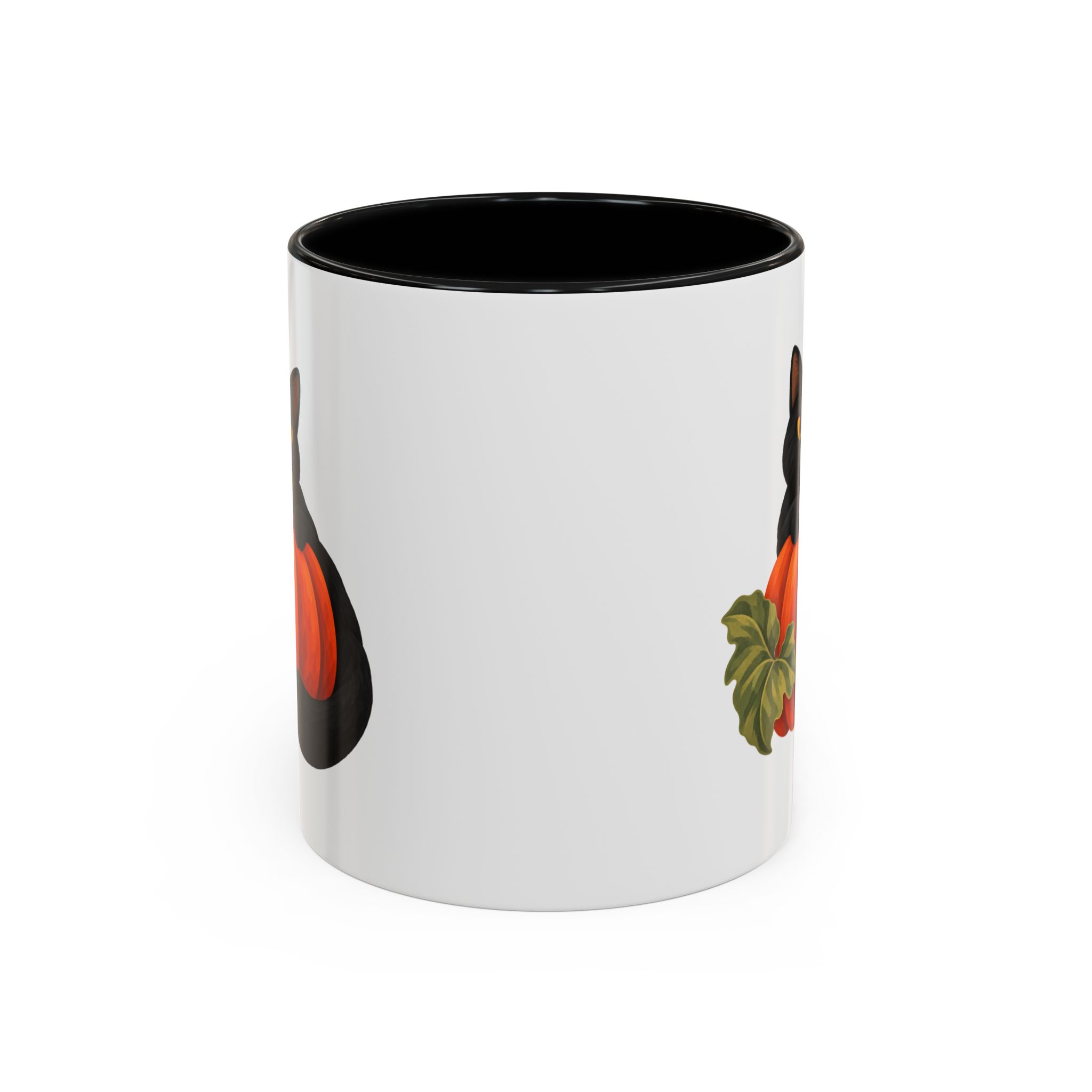 White 11 oz accent mug with a black interior, viewed opposite the handle, with the edges of the cat and pumpkin artwork visible on both sides.