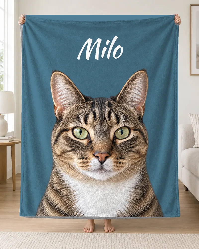 Milo’s portrait and name on a blue personalized cat blanket.