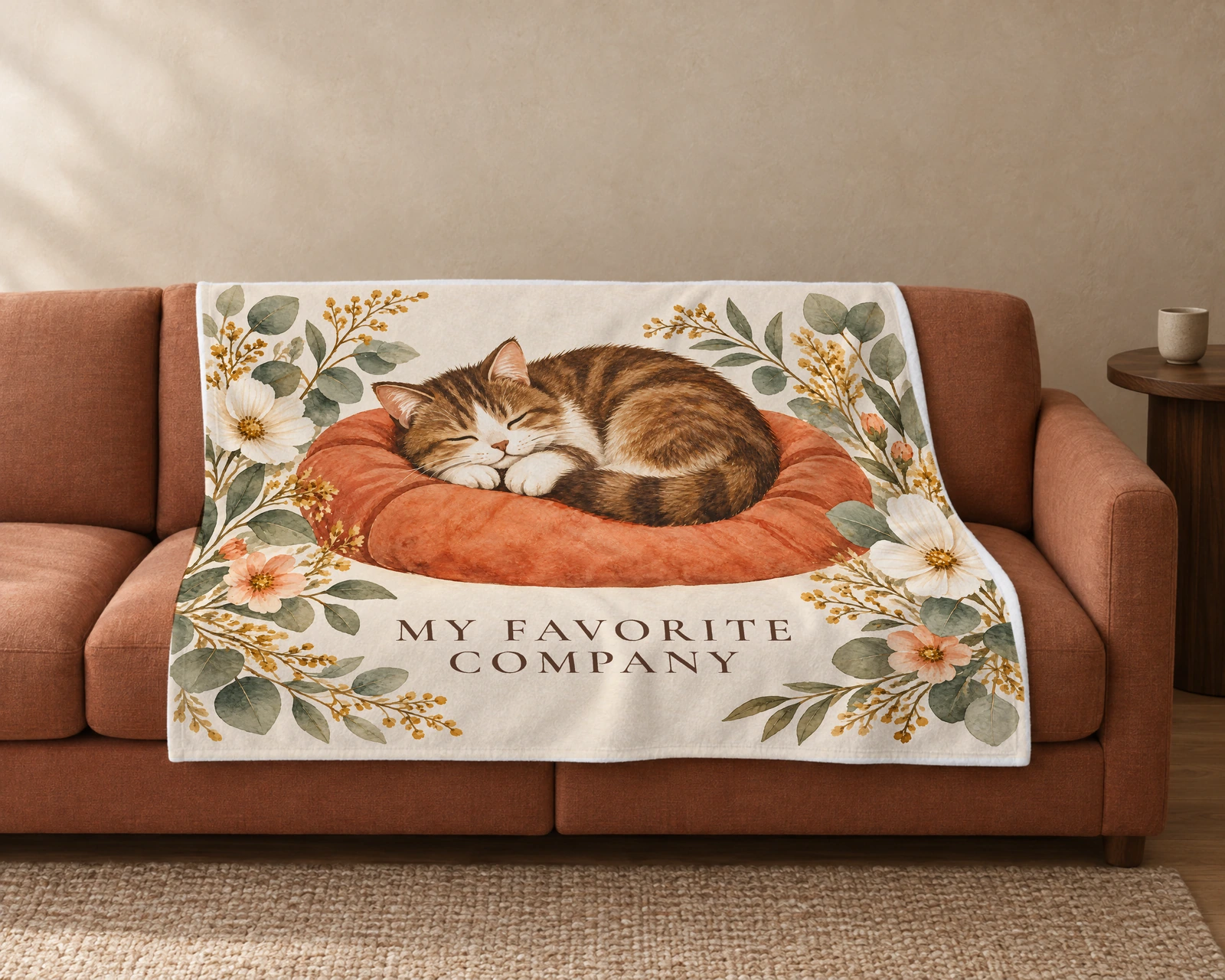 Cream blanket on a sofa with a sleeping brown-and-white tabby in watercolor and My Favorite Company.