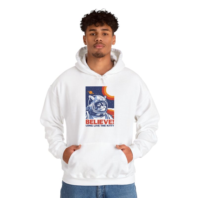 Person wearing a hoodie showing a gray tabby astronaut, a ringed golden planet and stars on deep blue