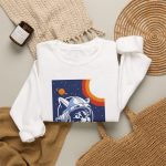 Close view of a gray tabby astronaut, a ringed golden planet and stars on deep blue in the front print Close view of a gray tabby astronaut, a ringed golden planet and stars on deep blue in the front print