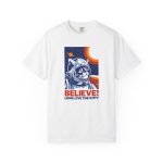 Front of the tee showing a gray tabby astronaut, a ringed golden planet and stars on deep blue Front of the tee showing a gray tabby astronaut, a ringed golden planet and stars on deep blue