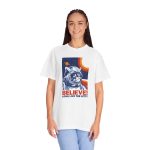 Person wearing a tee showing a gray tabby astronaut, a ringed golden planet and stars on deep blue Person wearing a tee showing a gray tabby astronaut, a ringed golden planet and stars on deep blue