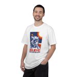 Person wearing a tee showing a gray tabby astronaut, a ringed golden planet and stars on deep blue Person wearing a tee showing a gray tabby astronaut, a ringed golden planet and stars on deep blue