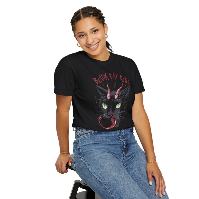 Person wearing a tee showing a horned black cat with green eyes, a curling red tongue and angular red lettering