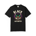 Front of the tee showing a grinning black cat with huge green eyes, orange mouth outlines and a purple halo
