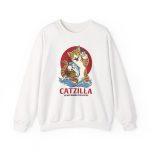 Front of the crewneck sweatshirt showing a giant brown tabby holding a blue fish above waves in front of a red sun disc