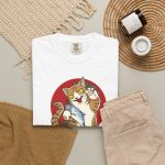 Close view of a giant brown tabby holding a blue fish above waves in front of a red sun disc in the front print