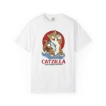 Front of the tee showing a giant brown tabby holding a blue fish above waves in front of a red sun disc