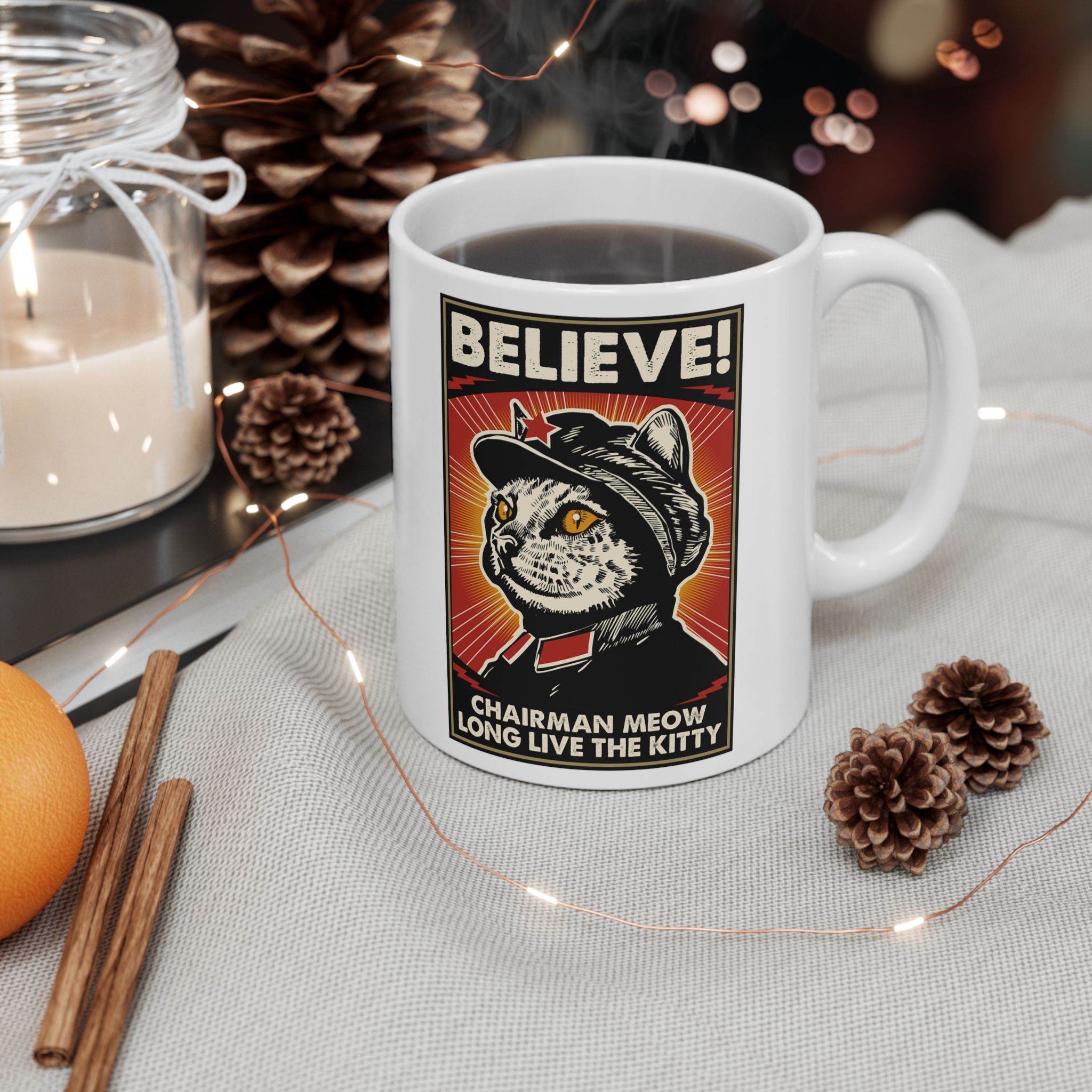 Glossy white ceramic mug showing a stern black-and-cream cat in a red-star cap with orange-red sunburst rays and a black frame