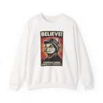 Front of the crewneck sweatshirt showing a stern black-and-cream cat in a red-star cap with orange-red sunburst rays and a black frame