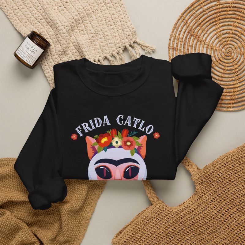 A pale pink cat with a unibrow, a flower crown, gold beads and a teal fish in the front print
