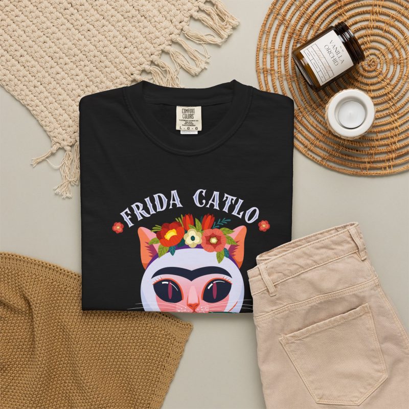 A pale pink cat with a unibrow, a flower crown, gold beads and a teal fish in the front print