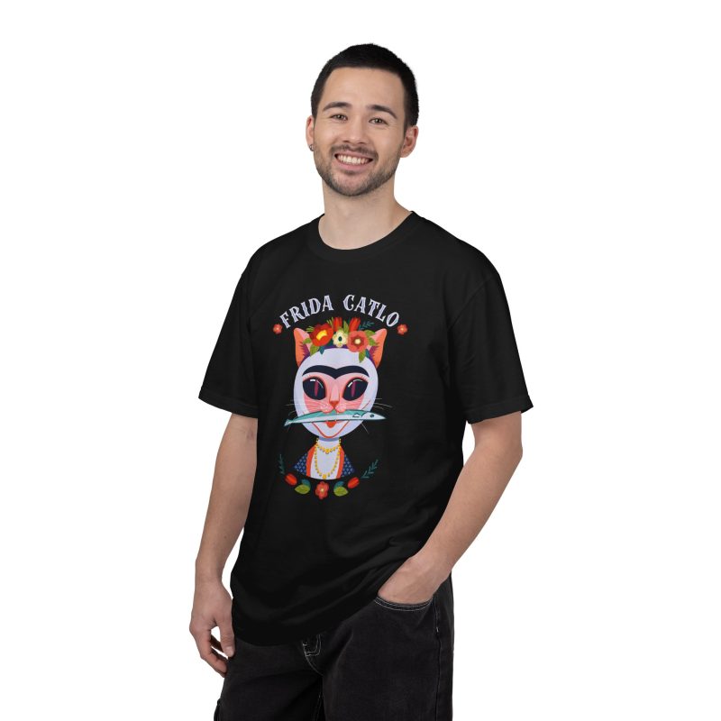 Person wearing a tee with a pale pink cat with a unibrow, a flower crown, gold beads and a teal fish printed on the front