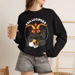 Person wearing a crewneck sweatshirt with a dark gray horned cat with yellow eyes, a skull, a pentagram and a flame inside a white dotted circle printed on the front Person wearing a crewneck sweatshirt with a dark gray horned cat with yellow eyes, a skull, a pentagram and a flame inside a white dotted circle printed on the front