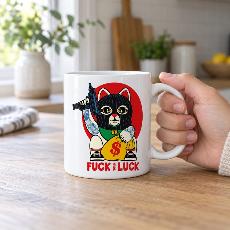 Person holding a glossy white ceramic mug showing a lucky cat in a black balaclava with blue arm tattoos, a submachine gun, a yellow money bag and a red disc