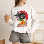 Person wearing a crewneck sweatshirt with a lucky cat in a black balaclava with blue arm tattoos, a submachine gun, a yellow money bag and a red disc printed on the front