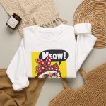 A white and ginger cat flexing its paw in a blue work shirt and red polka-dot bandana on a yellow panel in the front print