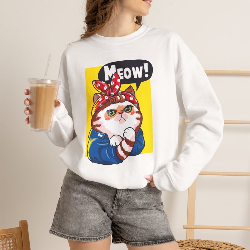 Person wearing a crewneck sweatshirt with a white and ginger cat flexing its paw in a blue work shirt and red polka-dot bandana on a yellow panel printed on the front