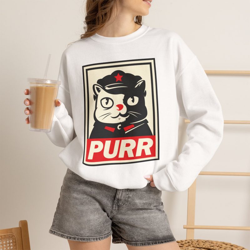 Person wearing a crewneck sweatshirt with a black and cream cat in a military cap with a red star above a red banner inside a double poster border printed on the front