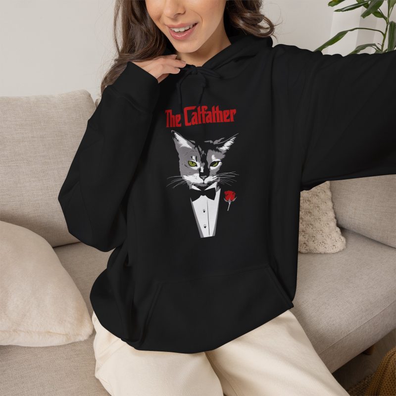 Person wearing a hoodie with a gray cat with green eyes in a white tuxedo shirt and black bow tie with a red rose printed on the front