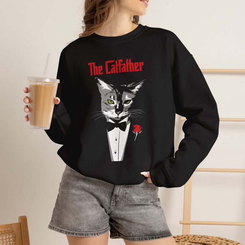Person wearing a crewneck sweatshirt with a gray cat with green eyes in a white tuxedo shirt and black bow tie with a red rose printed on the front
