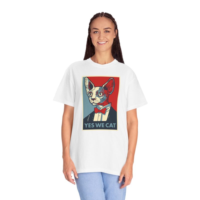 Person wearing a tee with a hairless cat in a suit and red bow tie printed on the front