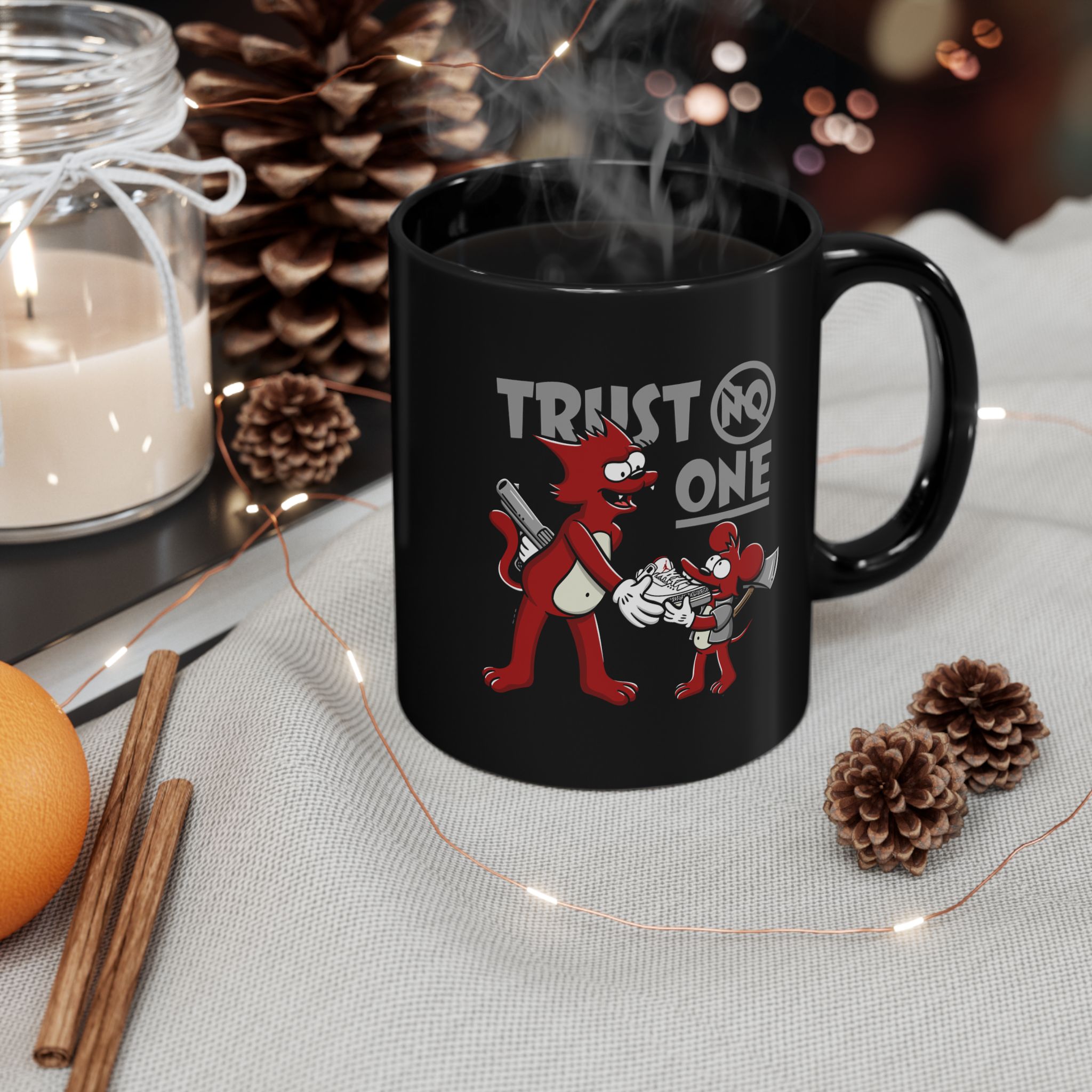 Glossy black ceramic mug showing a red cartoon cat and mouse trading a sneaker