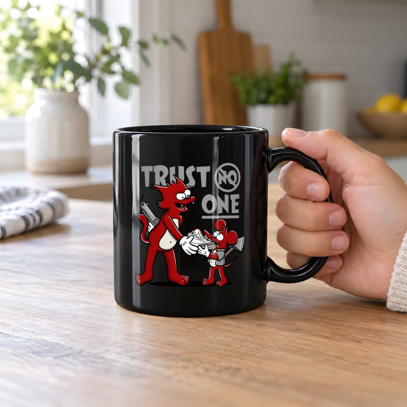 Person holding a glossy black ceramic mug with a red cartoon cat and mouse trading a sneaker