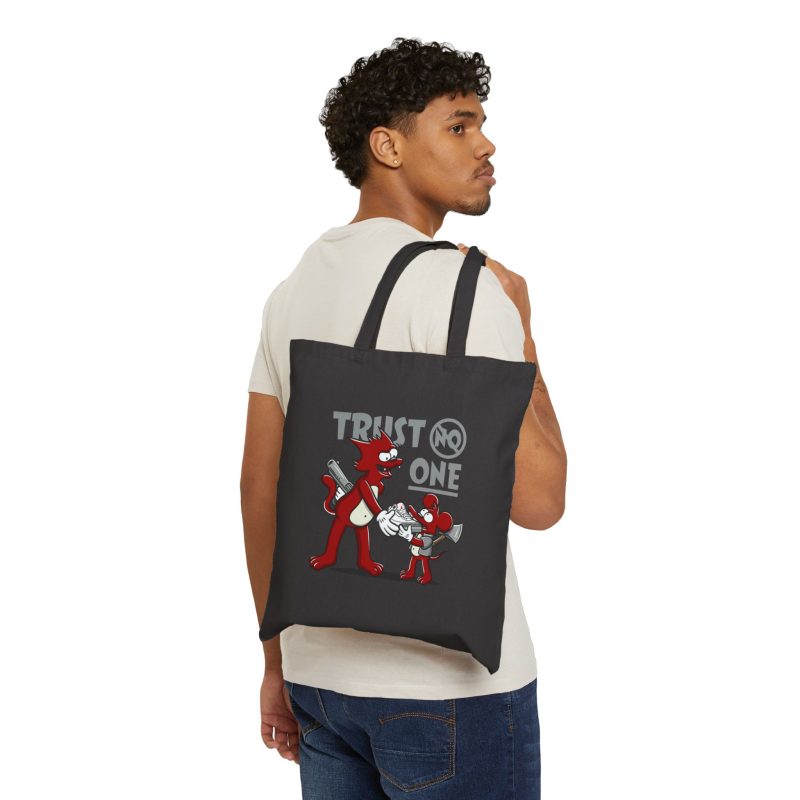 Person carrying a black canvas tote with a red cartoon cat and mouse trading a sneaker facing outward