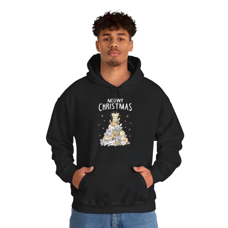 Person wearing a hoodie with white, gray, cream and ginger kittens stacked into a Christmas tree, surrounded by paw prints beneath white lettering printed on the front