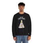 Person wearing a crewneck sweatshirt with white, gray, cream and ginger kittens stacked into a Christmas tree, surrounded by paw prints beneath white lettering printed on the front