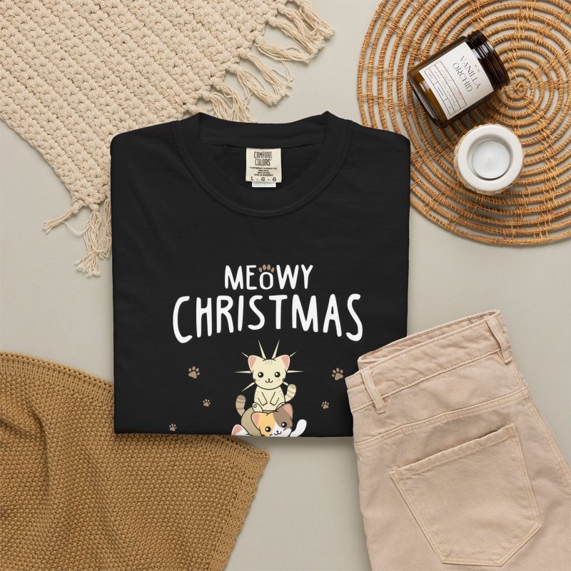 Stacked kittens, paw prints, a starburst and white MEOWY CHRISTMAS lettering in the front print