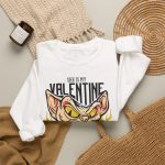 Peach-toned hairless cat baring its teeth amid yellow flames and bold black lettering in the front print Peach-toned hairless cat baring its teeth amid yellow flames and bold black lettering in the front print