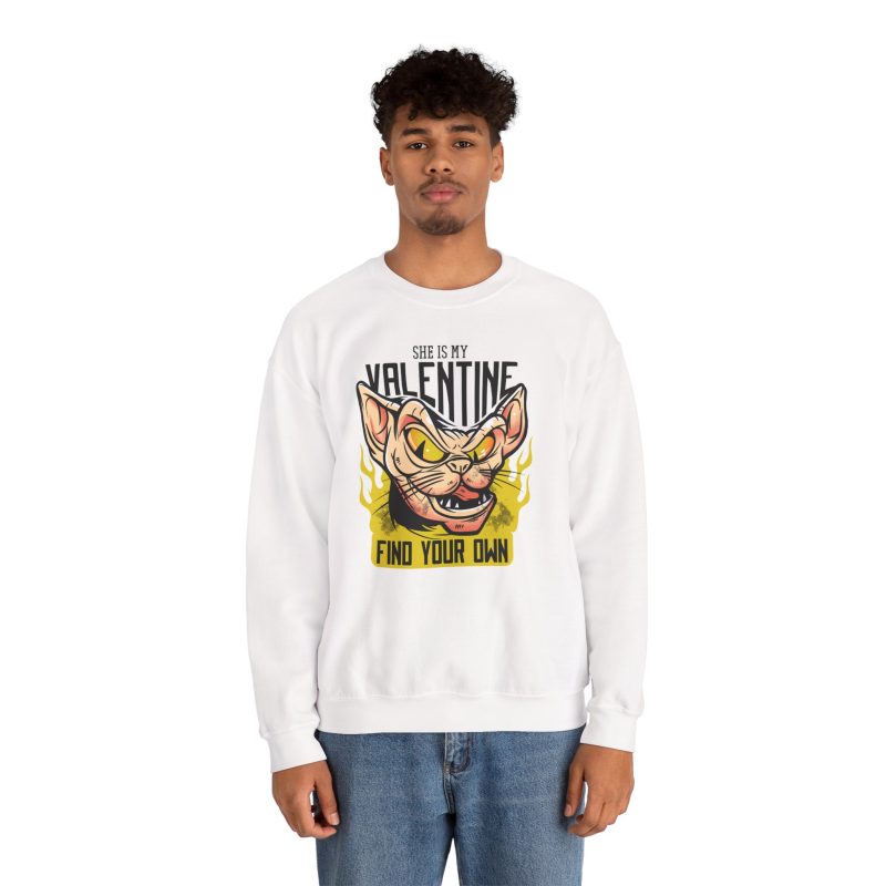 Person wearing a crewneck sweatshirt with a fierce hairless cat with yellow eyes and flames printed on the front