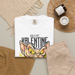Peach-toned hairless cat baring its teeth amid yellow flames and bold black lettering in the front print