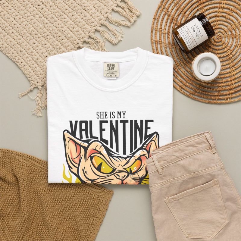 Peach-toned hairless cat baring its teeth amid yellow flames and bold black lettering in the front print