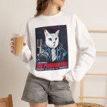 Person wearing a crewneck sweatshirt with a white cyborg cat with a red eye and leather jacket printed on the front