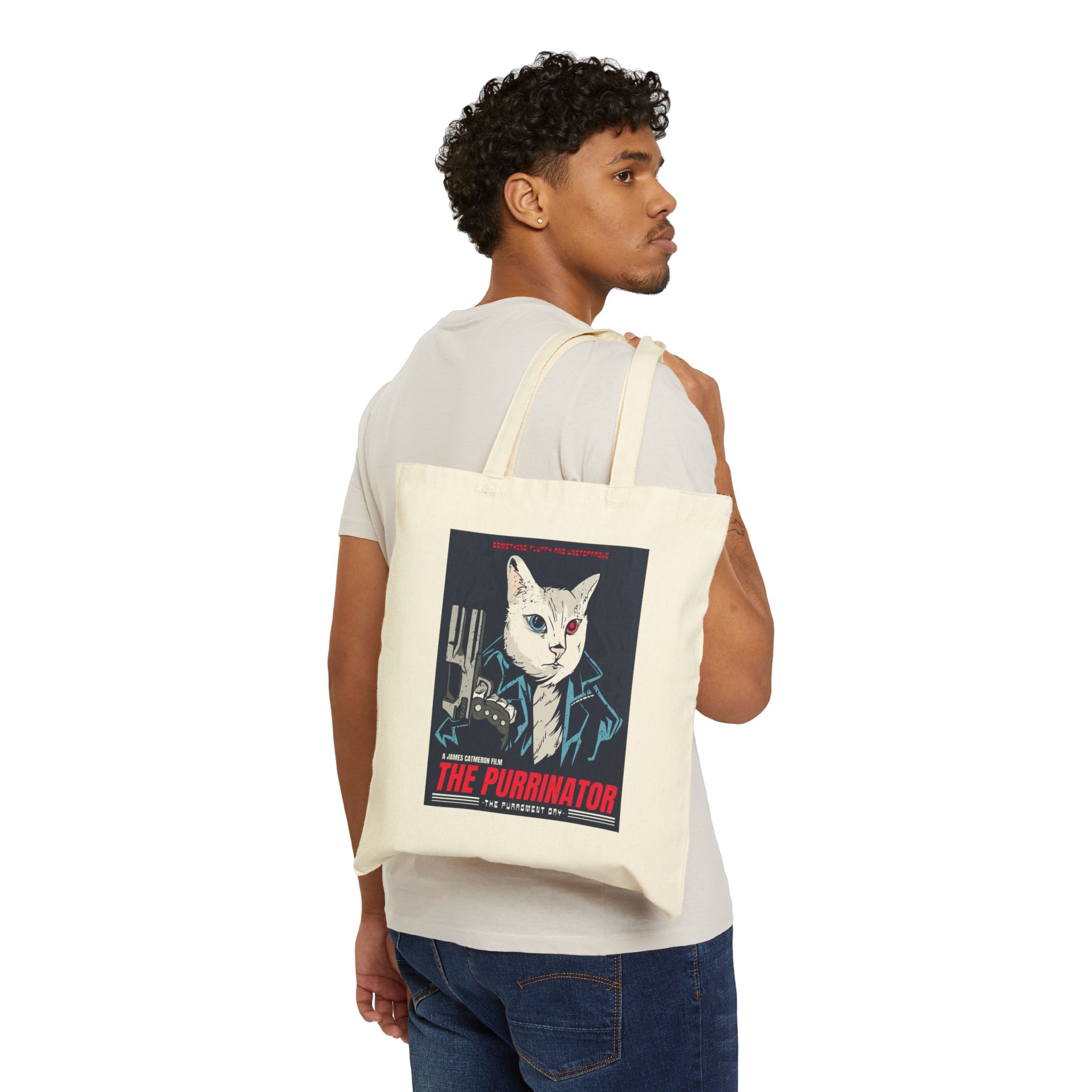 Person carrying a natural canvas tote with a white cyborg cat with a red eye and leather jacket facing outward