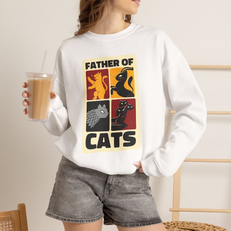 Person wearing a crewneck sweatshirt with four heraldic cat panels in red, gold, black and gray printed on the front
