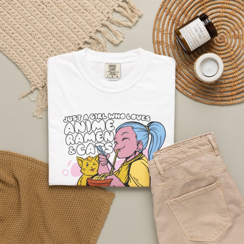 Blue-haired girl eating ramen beside a golden ginger cat and outlined lettering in the front print