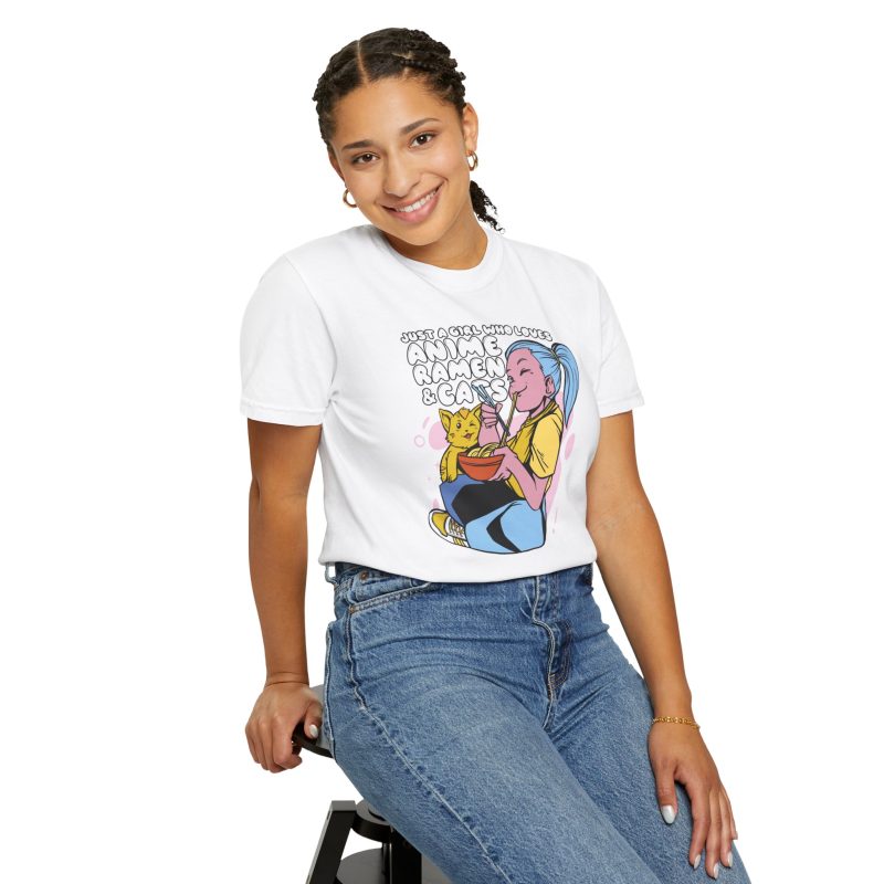 Person wearing a tee with a blue-haired girl eating ramen beside a golden ginger cat printed on the front
