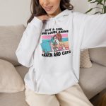 Person wearing a hoodie with a ramen-eating girl at a computer with three colorful cats printed on the front Person wearing a hoodie with a ramen-eating girl at a computer with three colorful cats printed on the front