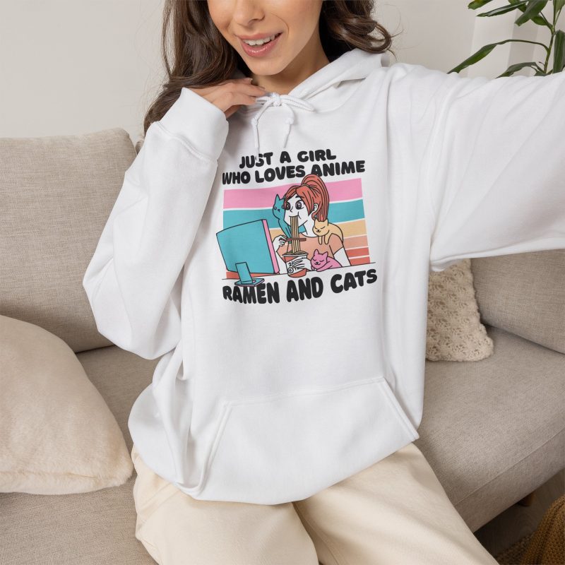 Person wearing a hoodie with a ramen-eating girl at a computer with three colorful cats printed on the front