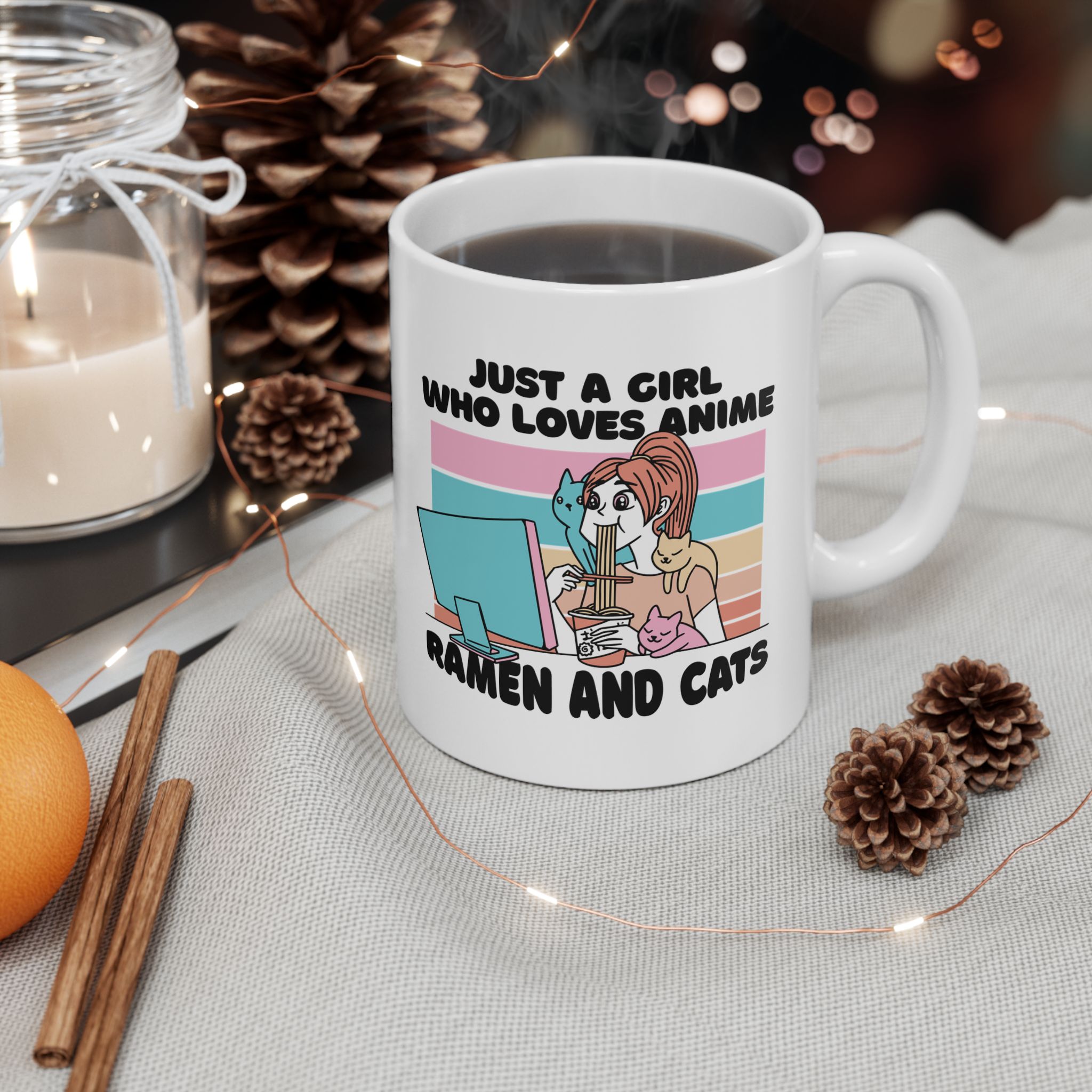 White ceramic mug showing a ramen-eating girl at a computer with three colorful cats