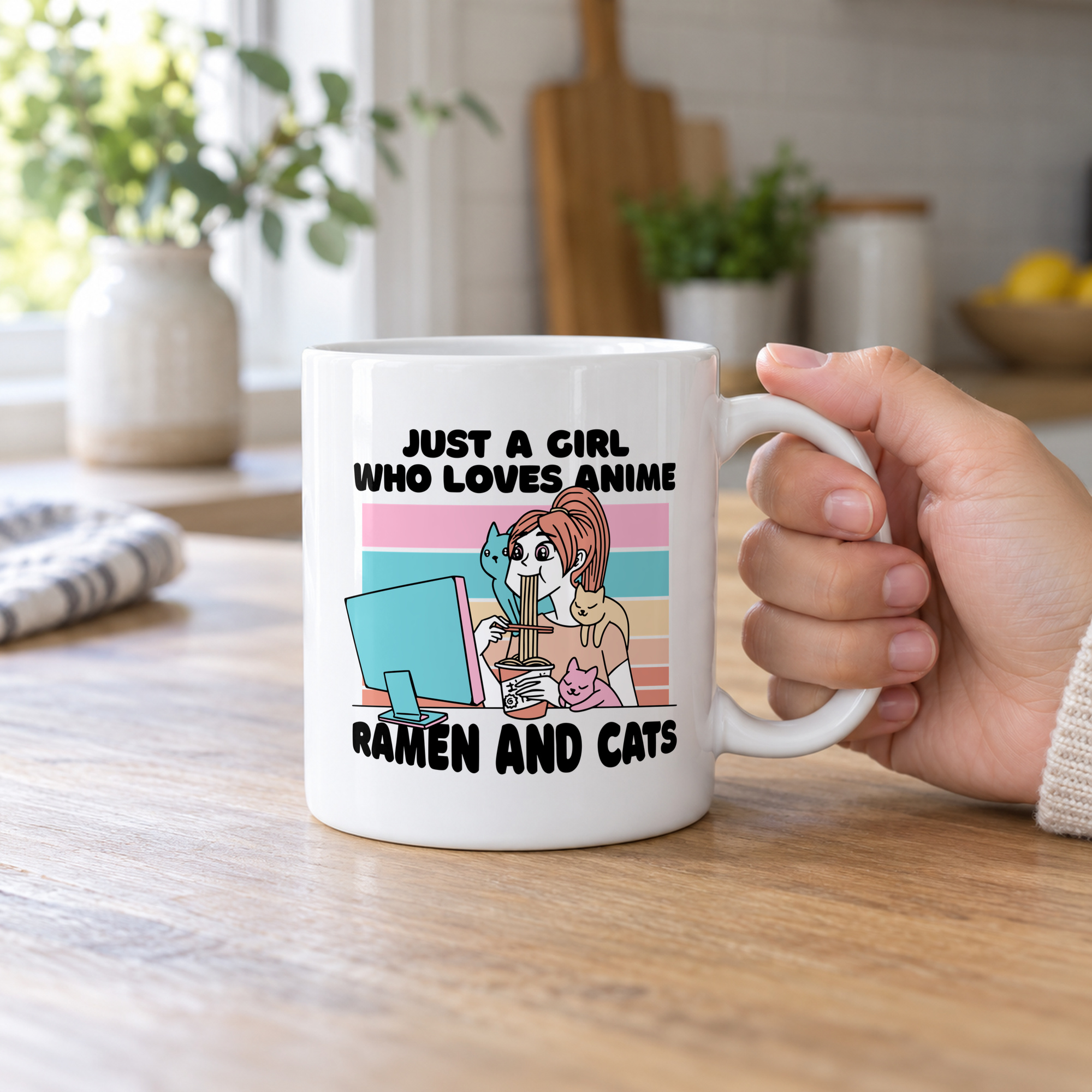 Person holding a white ceramic mug showing a ramen-eating girl at a computer with three colorful cats