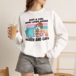Person wearing a crewneck sweatshirt with a ramen-eating girl at a computer with three colorful cats printed on the front Person wearing a crewneck sweatshirt with a ramen-eating girl at a computer with three colorful cats printed on the front