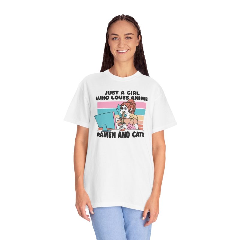 Person wearing a tee with a ramen-eating girl at a computer with three colorful cats printed on the front