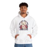 Person wearing a hoodie with a winking pale cream cat framed by red roses and green leaves printed on the front
